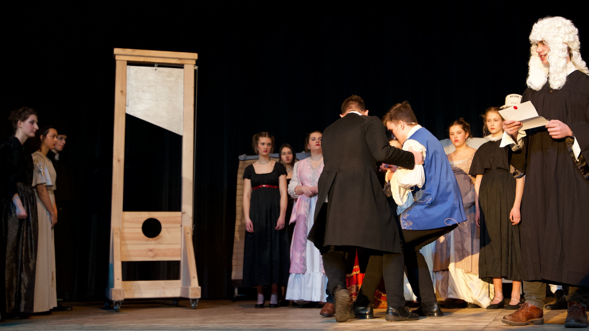 a guillotine displayed on stage in a theater