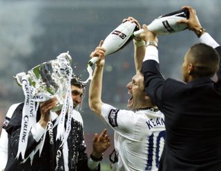 Juande Ramos is covered in Champagne by Robbie Keane after Tottenham's League Cup final win over Chelsea in February 2008.