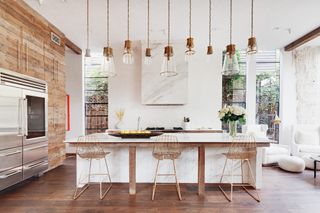american cottage kitchen with rough wood clad walls and island