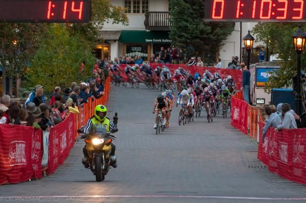 The men's peloton heads out of the final corner to the start/finish line in Vail.