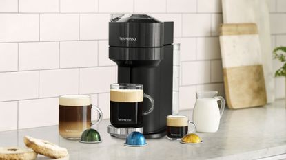 Nespresso Vertuo coffee machine lifestyle on kitchen worktop with different size coffee mugs 