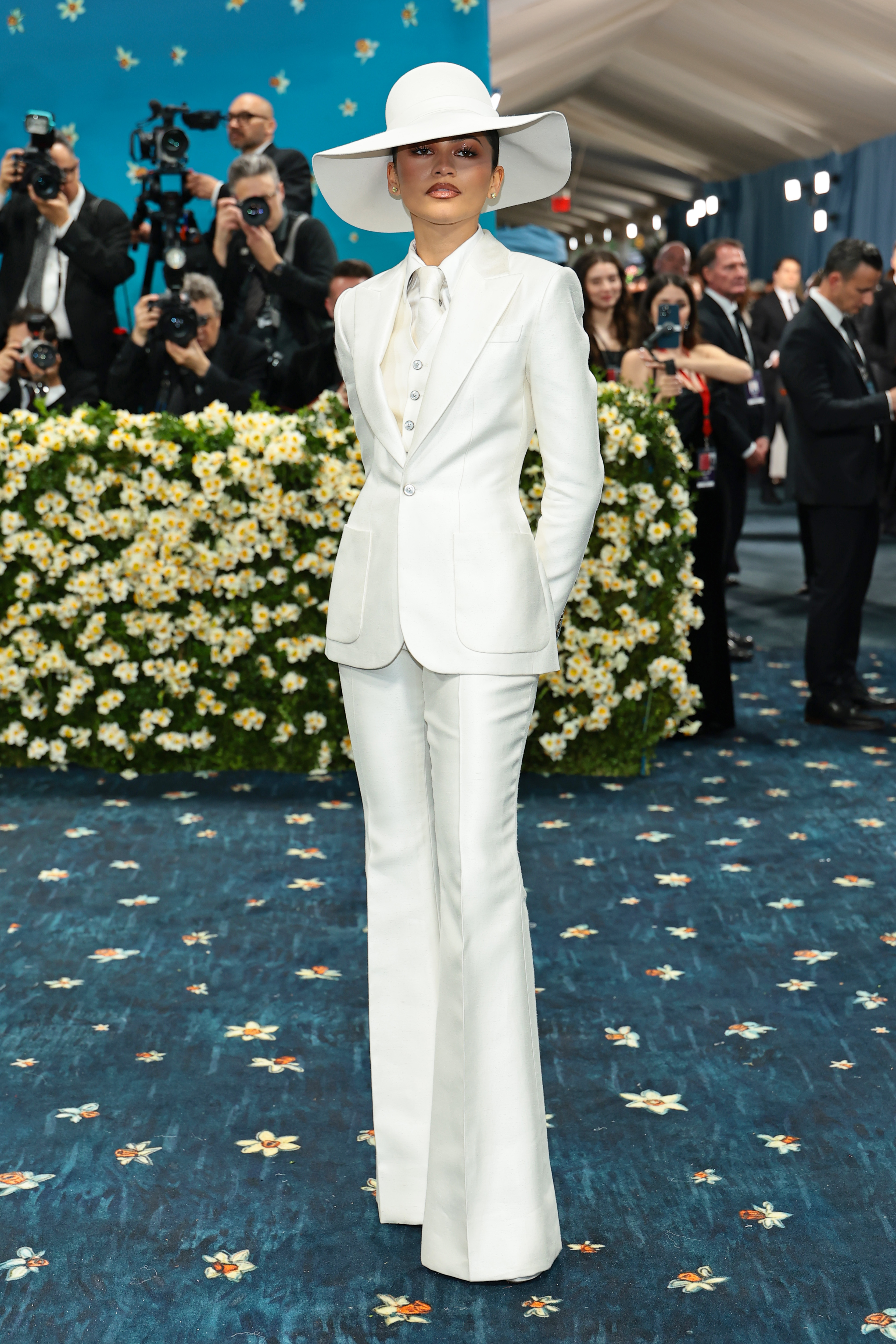 Zendaya wears a white suit.