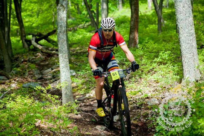 Matt Lough descends through the wooded rocky trail of the enduro stage.
