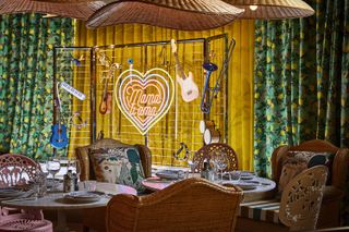 The eclectic hotel lounge area with Neon love sign at Mama Roma