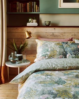 a bedroom with a wooden headboard and shelf above the bed