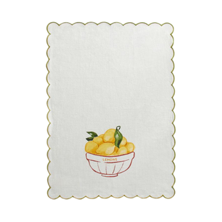 White kitchen towel with green scalloped edge and a printed illustration of a bowl of lemons