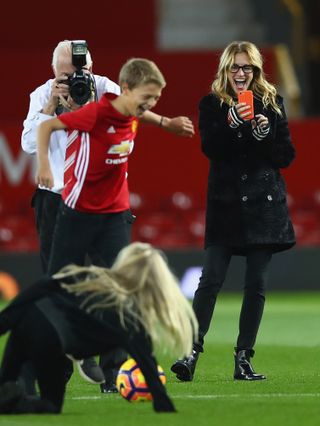 Julia Roberts takes photos of her children on the pitch after the Premier League match between Manchester United and West Ham United at Old Trafford on November 27, 2016 in Manchester, England.