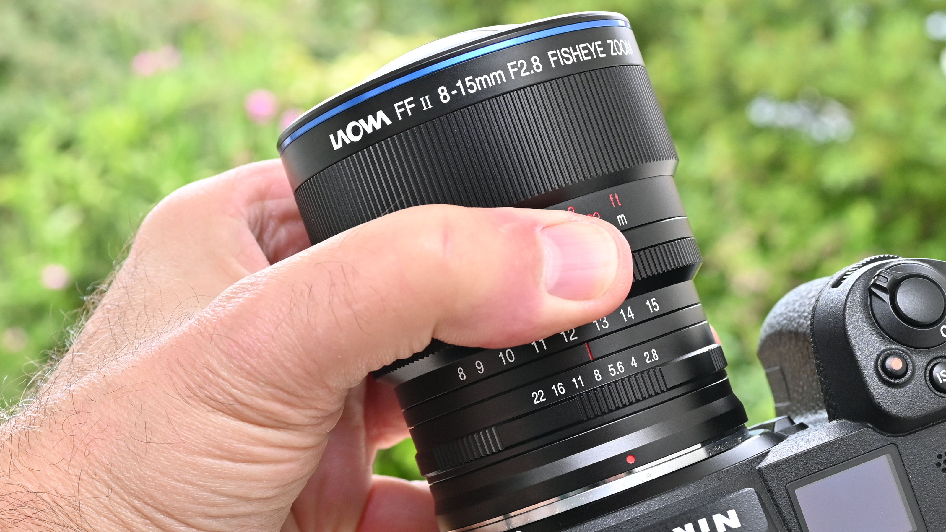 Laowa 8-15mm f/2.8 FF Zoom Fisheye product image of lens held in hand