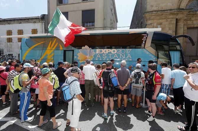 Fans gather outside the Astana bus