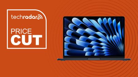 Apple 2026 MacBook Air 13-inch Laptop with M5 chip in midnight blue color on orange background with TechRadar price cut sign