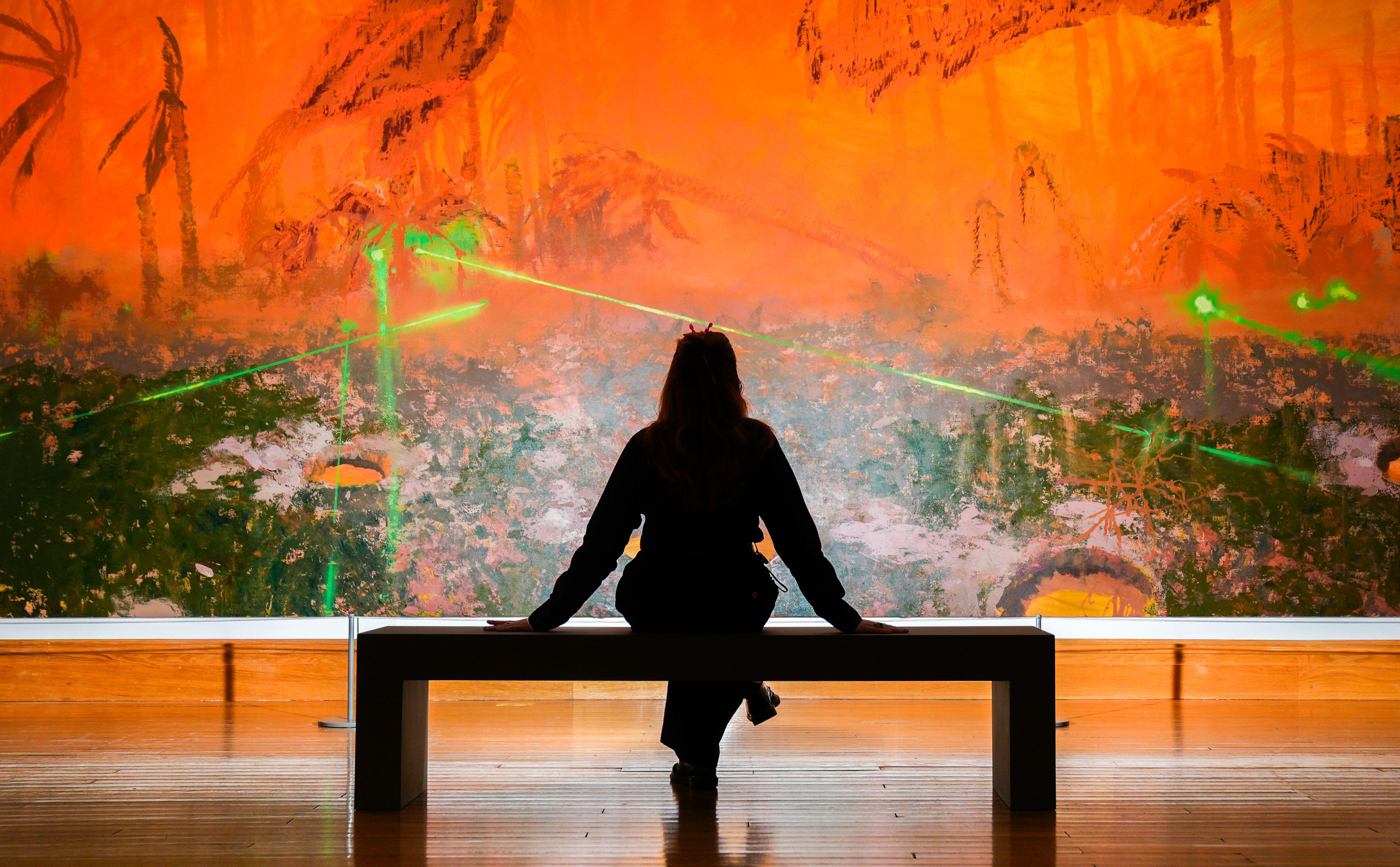 A woman views a work by nominated artist Mohammed Sami 