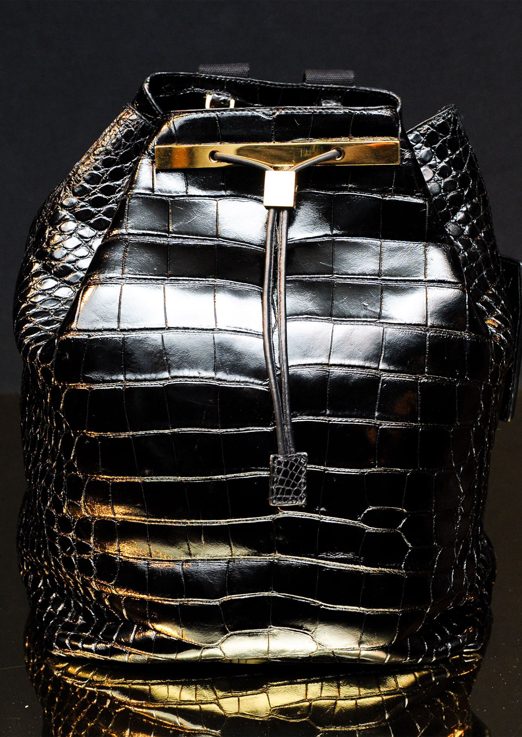 a close up of one of The Row's alligator bags