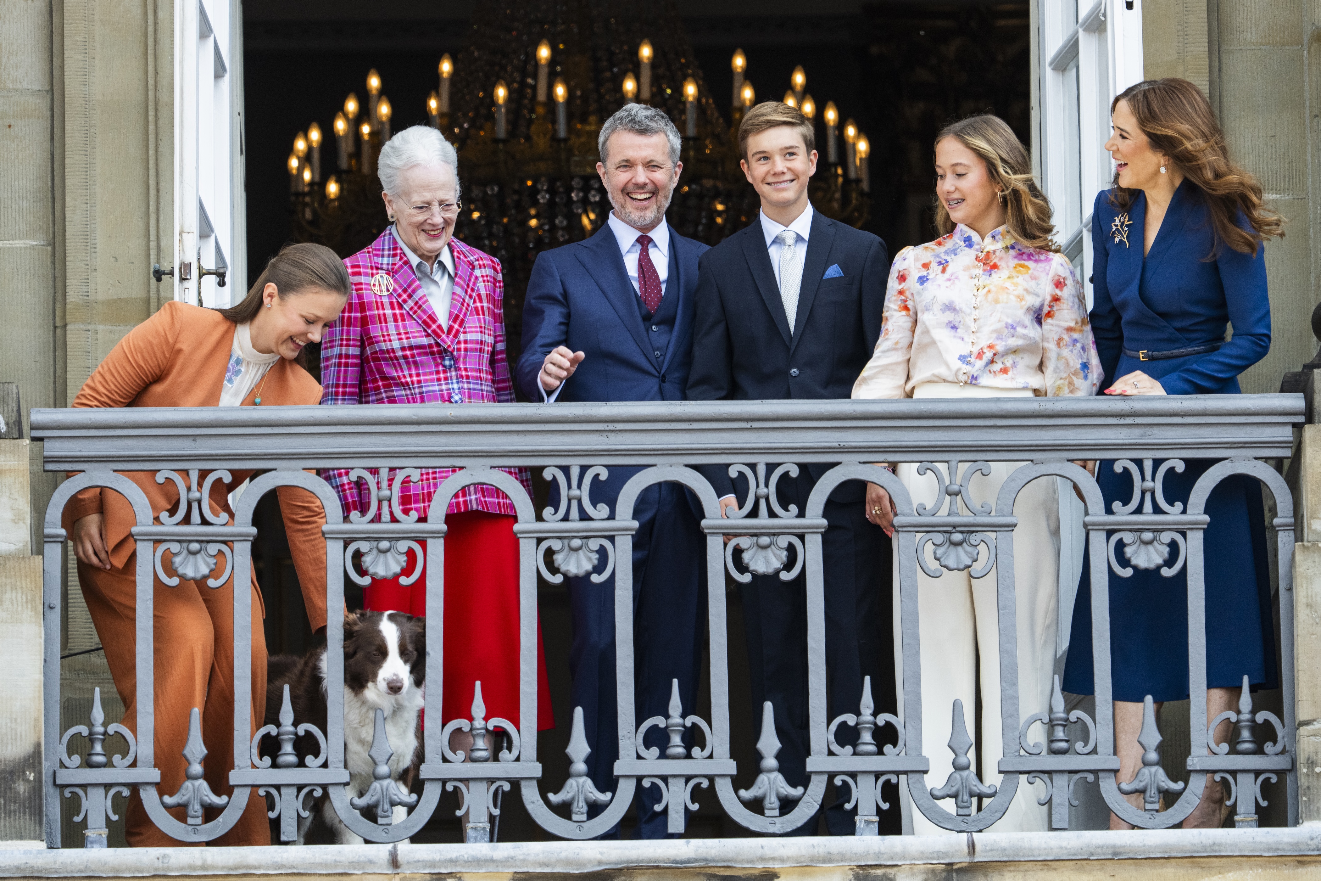 Princess Isabella of Denmark, Queen Margrethe of Denmark, King Frederik X of Denmark, Prince Vincent of Denmark, Princess Josephine of Denmark, Queen Mary of Denmark and their dog on the balcony
