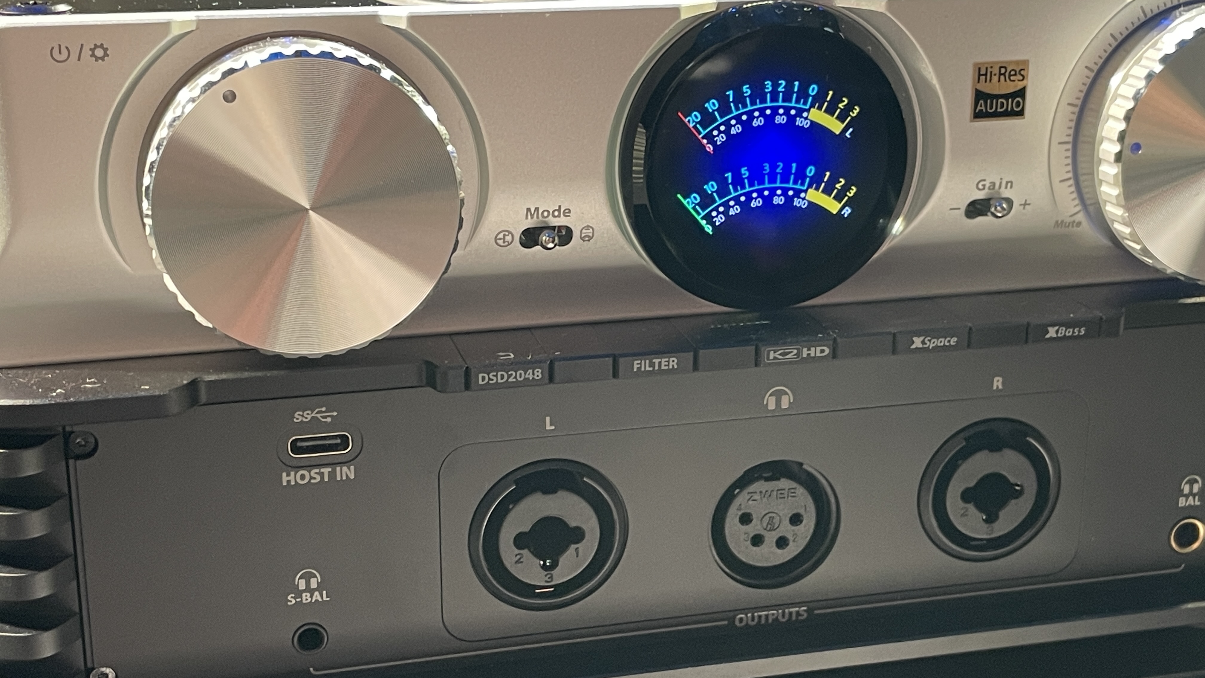 The formidable iFi iDSD Phantom in Tower Bridge, London, used with headphones and illuminating the front panel 