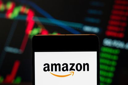 the American electronic commerce and cloud computing company Amazon (NASDAQ: AMZN) logo seen displayed on a smartphone with a graph in the background. 