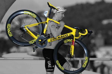 Tadej Pogacar shoulders his bike at the podium ceremony of the 2024 Tour de France