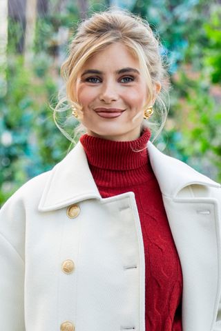 Woman with undone updo hairstyle, a key New York Fashion Week street style beauty trend