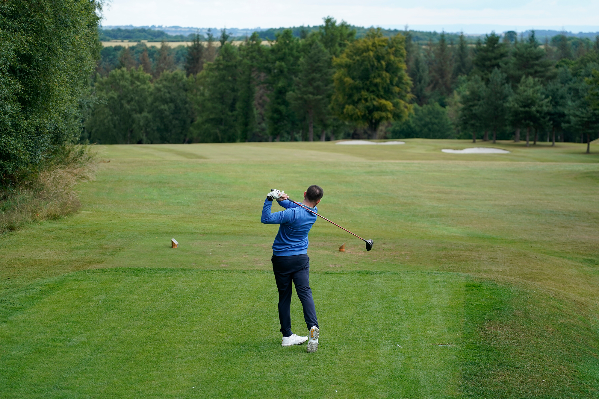 Baz Plummer in the finish position after hitting driver on the tee box at the 3rd hole at Sand Moor Golf Club