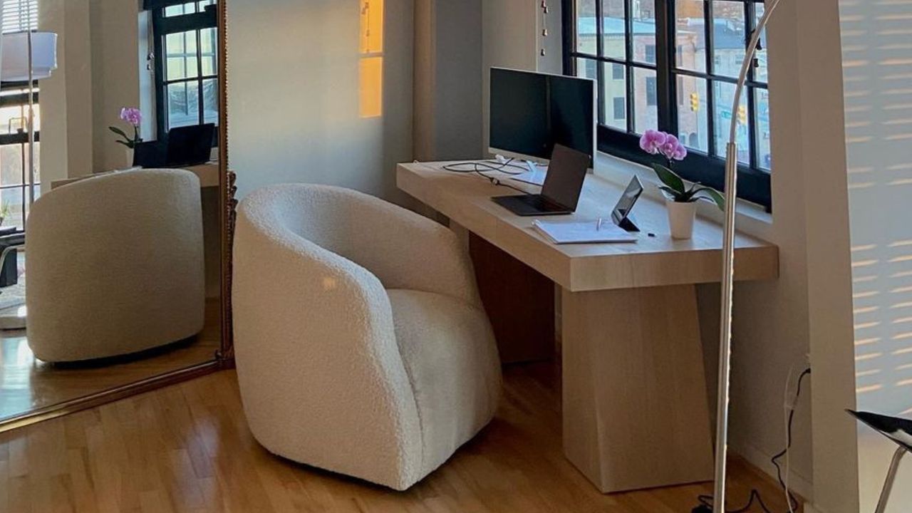 Desk with computer and boucle chair