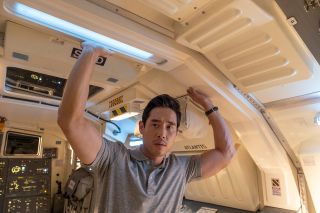 Dr. Ben Song (Raymond Lee) aboard the space shuttle flight deck in the "Quantum Leap" episode "Atlantis."