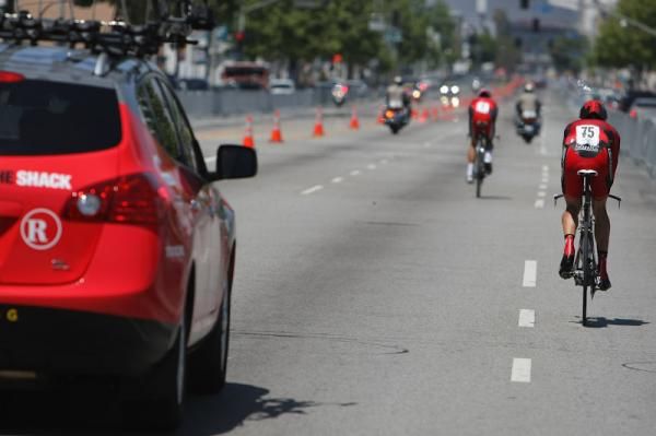 The Radioshack team car overtakes Chad Beyer (BMC Racing Team)
