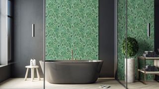 bathroom with steel bath and green wallpaper