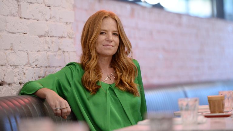 Patsy Palmer in green top sitting in london cafe