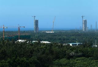 Work on China's newest spaceport on Hainan Island is in full swing with rocket assembly towers stretching into the sky.