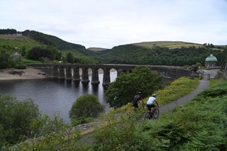 Image shows two cyclists riding in the Elan Valley, Wales