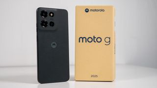 The black Moto G 2025 with its small cardboard box