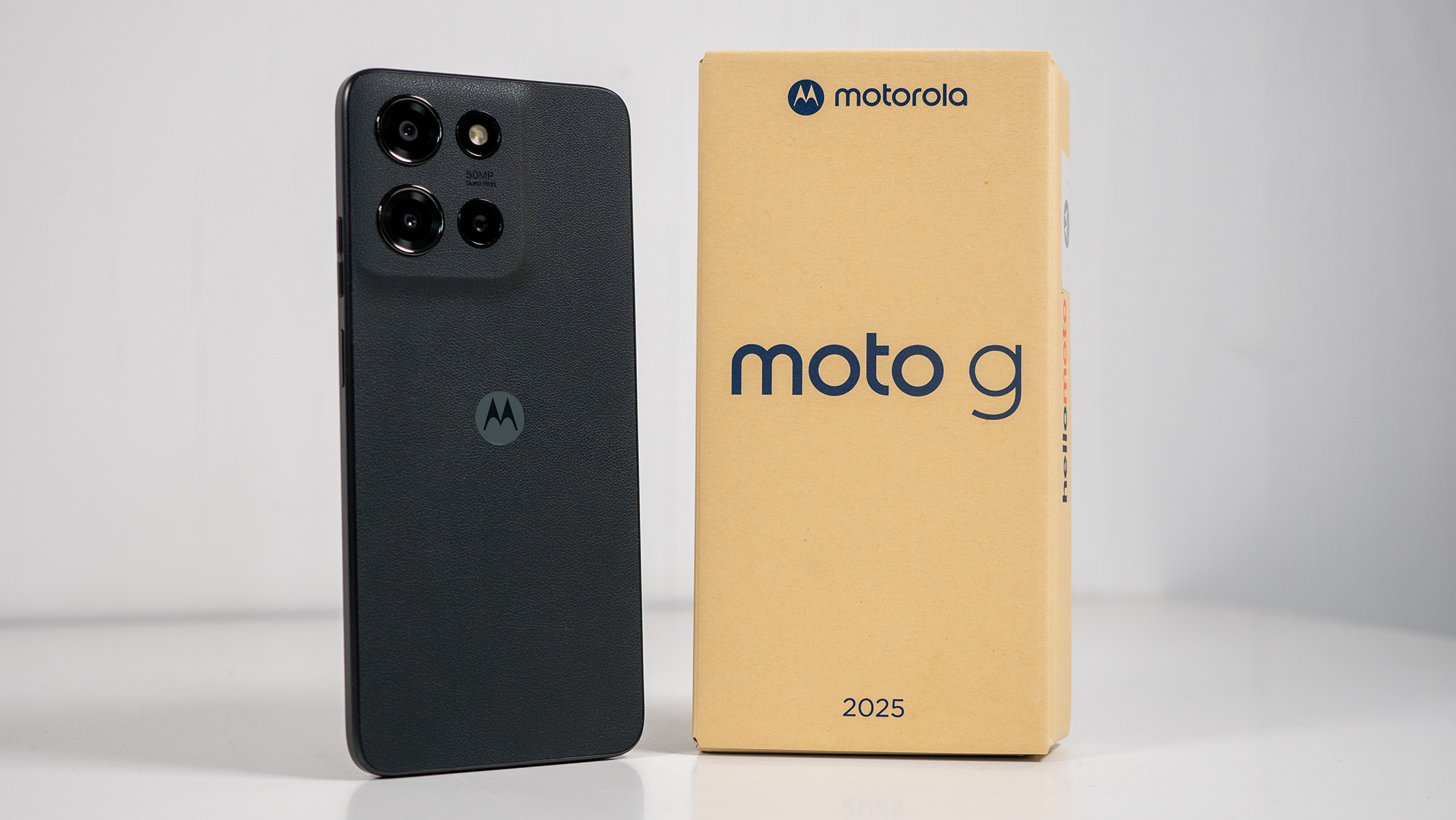 The black Moto G 2025 with its small cardboard box