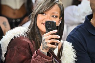 Rihanna films from front row of runway show