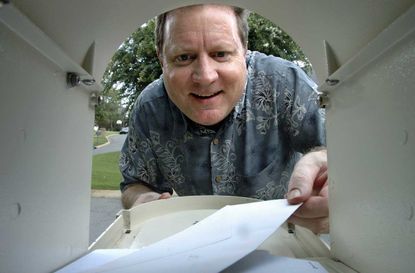 photo of man opening mailbox
