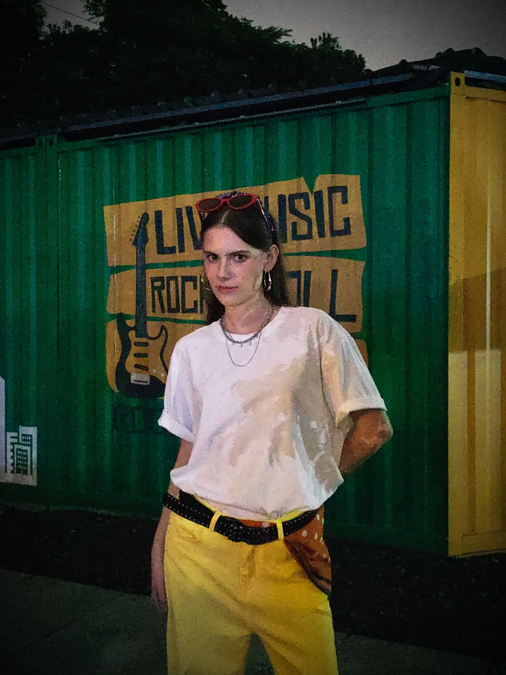 A woman posing for a photo in a dark scene