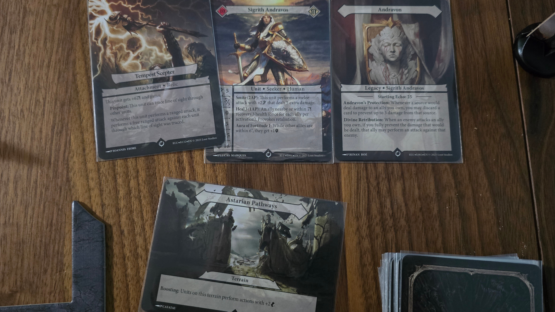 Malediction cards and tokens laid out on a wooden surface