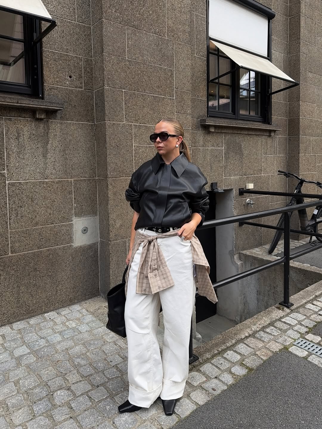 Woman wearing collared leather jacket trend fall 2025.