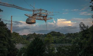 The Arecibo Observatory's radio telescope was built in a natural sinkhole in Puerto Rico, construction was completed in 1963.