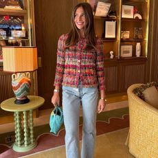 Hannah wears a tweed jacket and light-wash jeans.