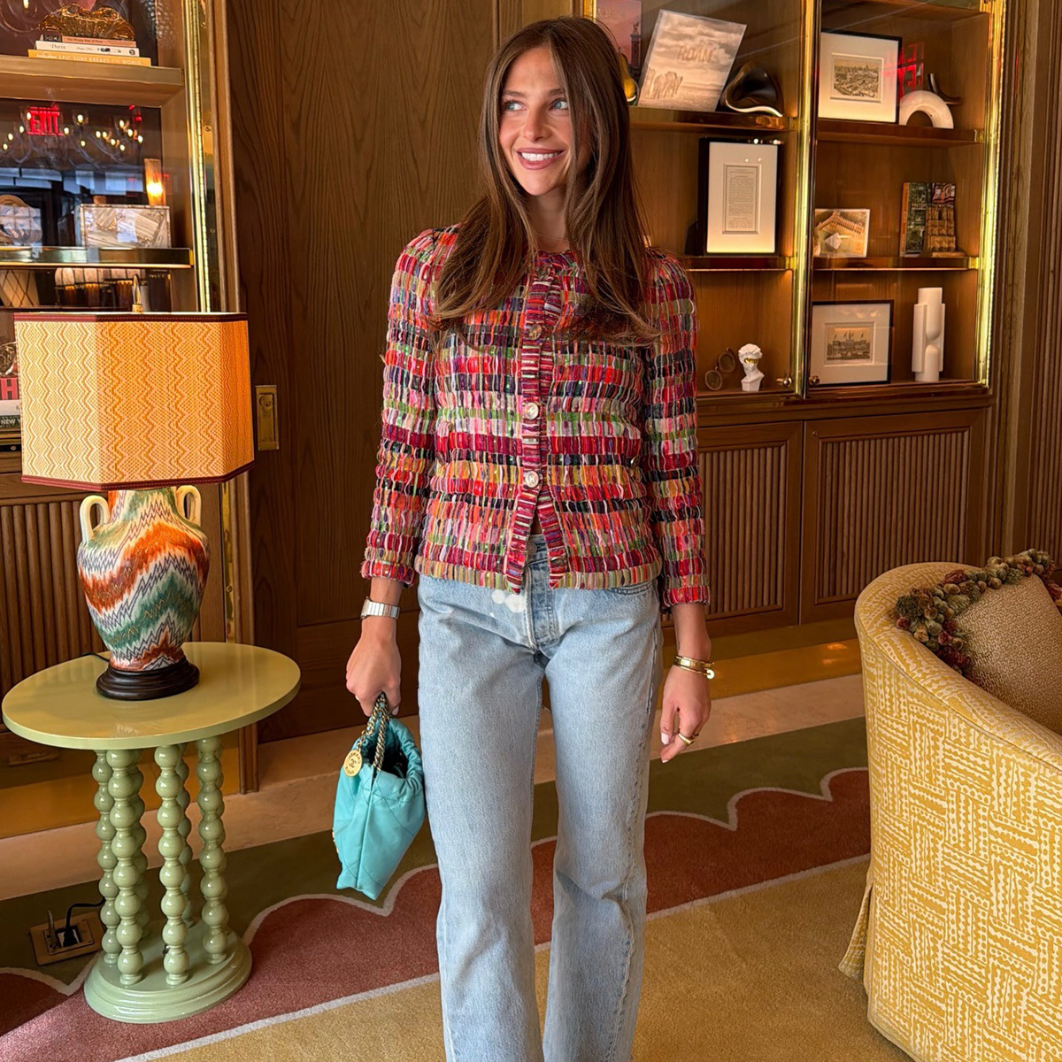 Hannah wears a tweed jacket and light-wash jeans.