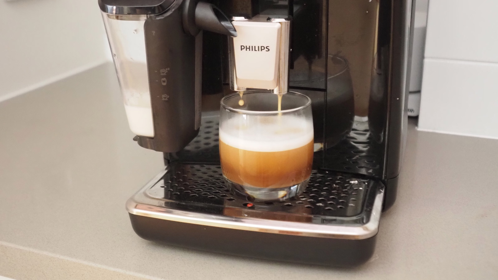 Philips 4400 Series LatteGo espresso machine pouring a flat white