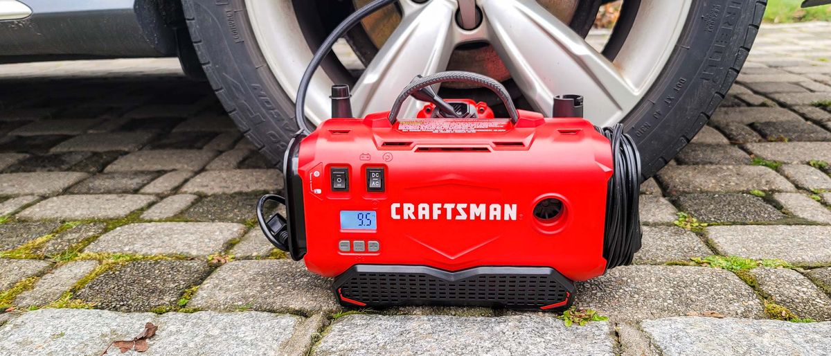 Craftsman V20 Cordless Tire Inflator next to car tire