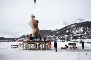 Photograph of Damien Hirst's Temple sculpture being installed on Lake St. Moritz