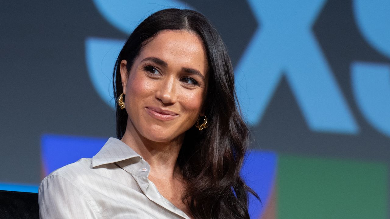 Meghan Markle smiles onstage at the SXSW International Womens Day panel