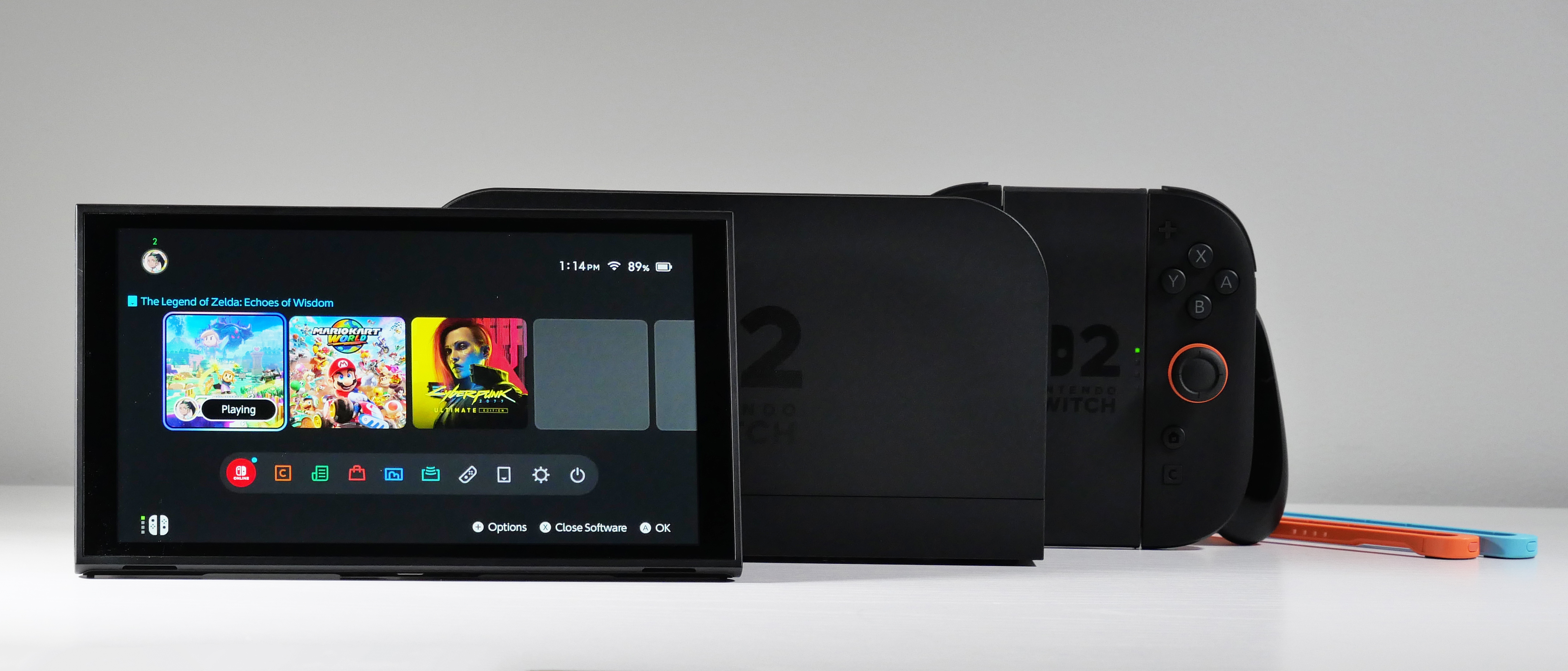 Nintendo Switch 2, Dock, Joy-Con 2 Grip, and Straps displayed on a white desk.