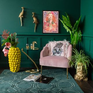 indoor plant ideas: funky potted plants in green room with pink armchair from AUDENZA