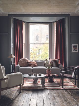 Grey living room with red curtains