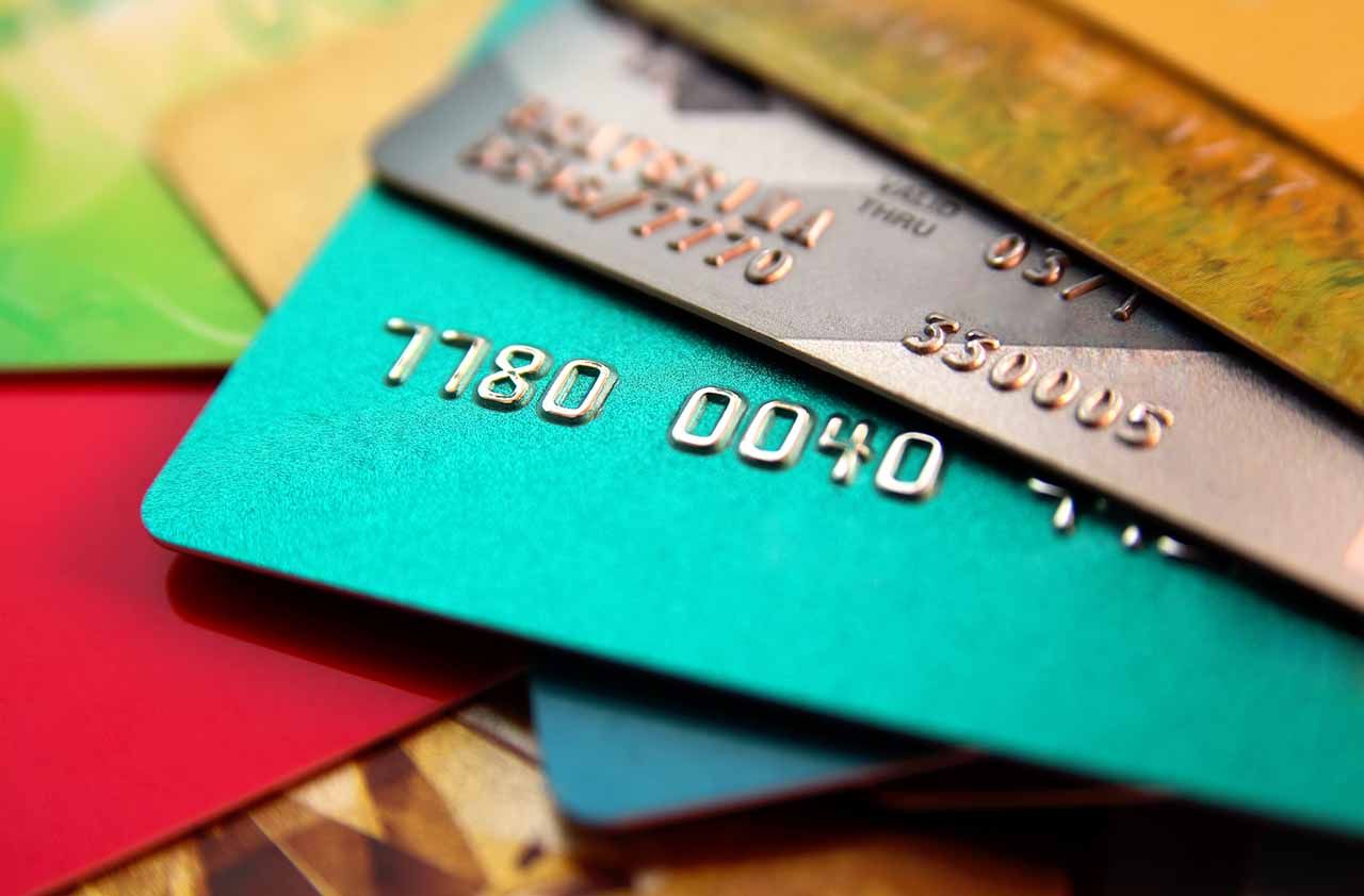 stack of multicolored credit cards, close up view with selective focus