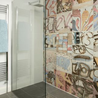 shower room with glass wall and graffiti-style tiles