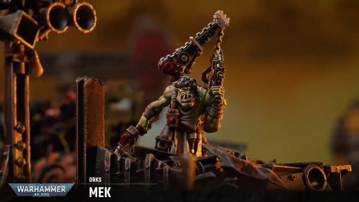 An Ork Mek stands amongst ruins