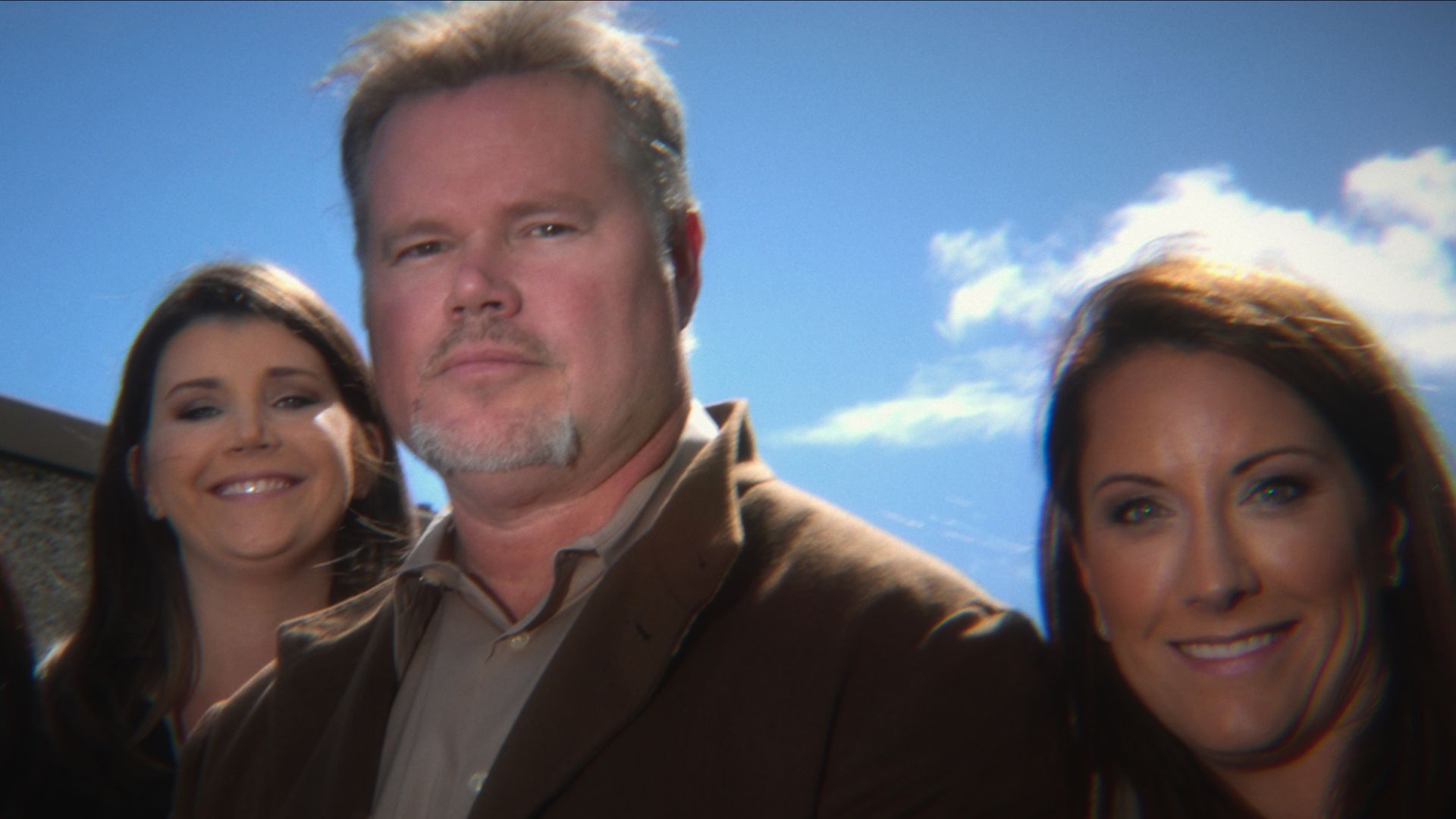 Chris Butler standing in between two female private investigators
